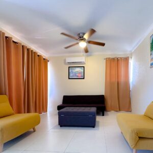 Modern living room with yellow chairs and paintings.