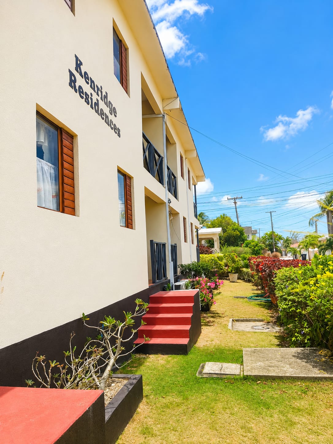Kenridge Residences exterior with garden and red steps